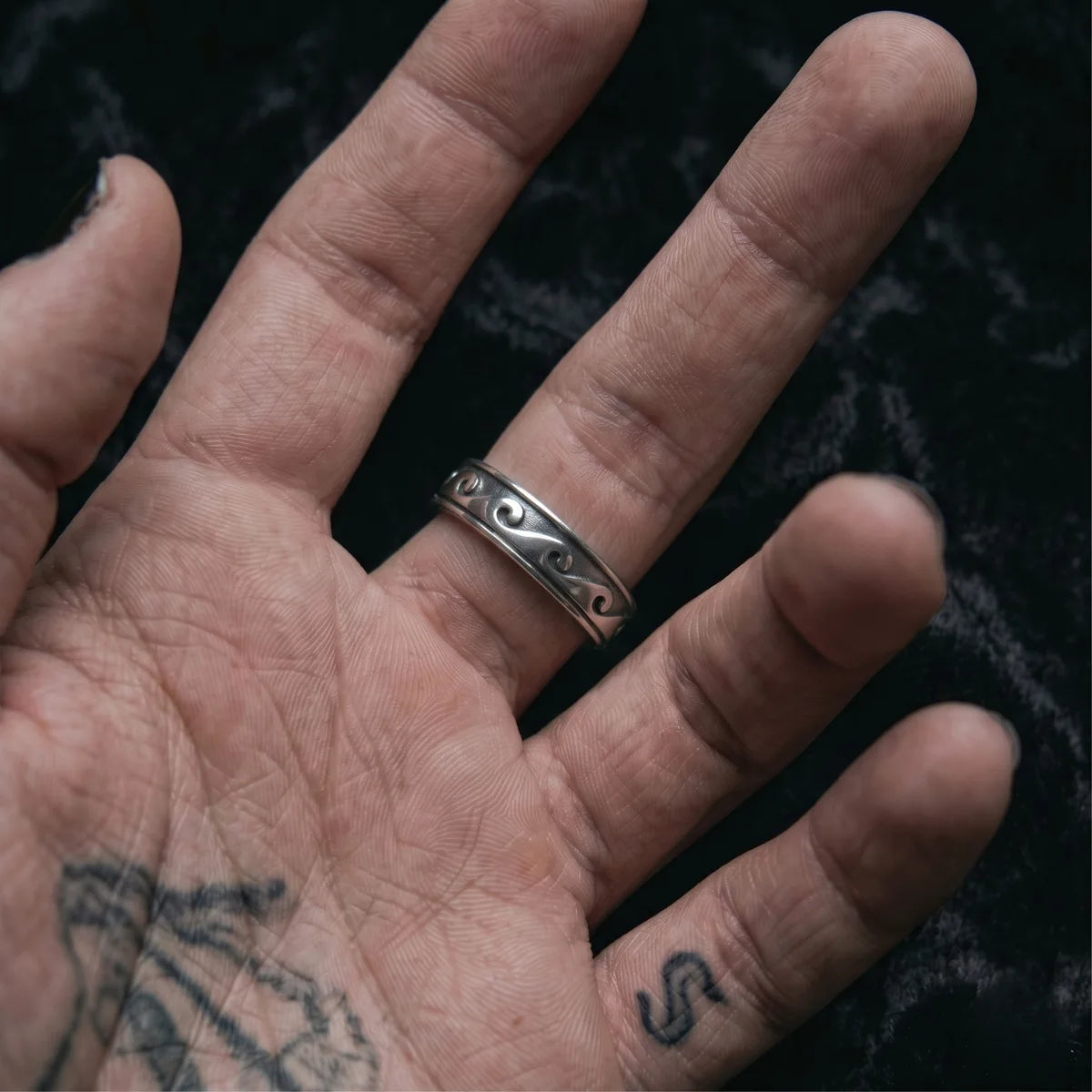 Wave Band Ring Silver Worn on Palm Up Hand Close Up
