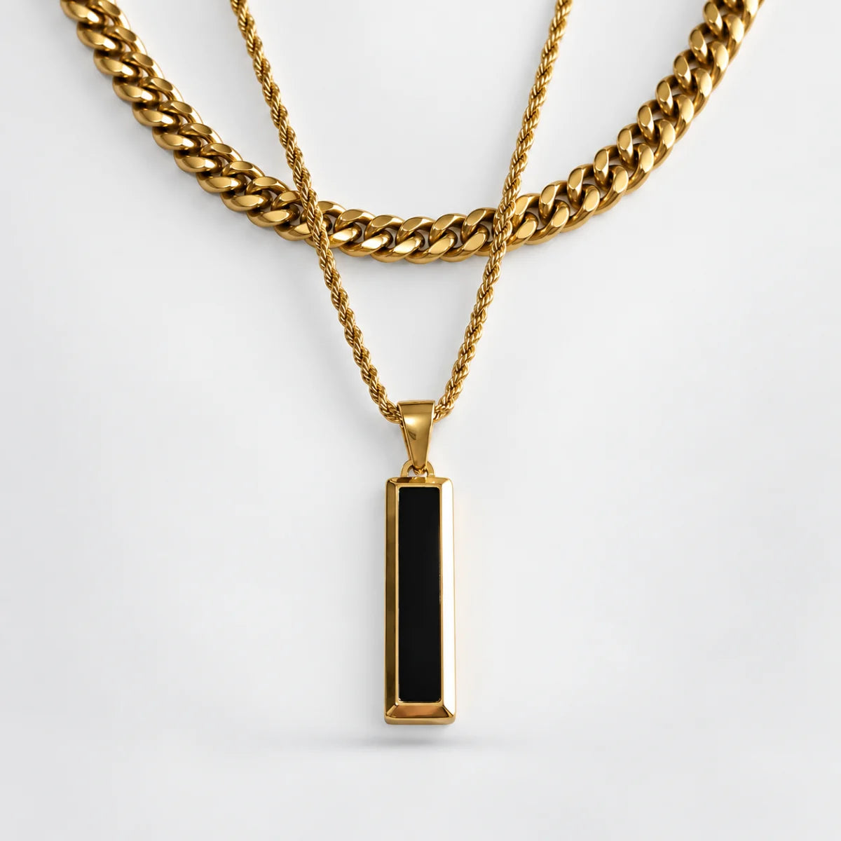 black and gold bar necklace layered set white background