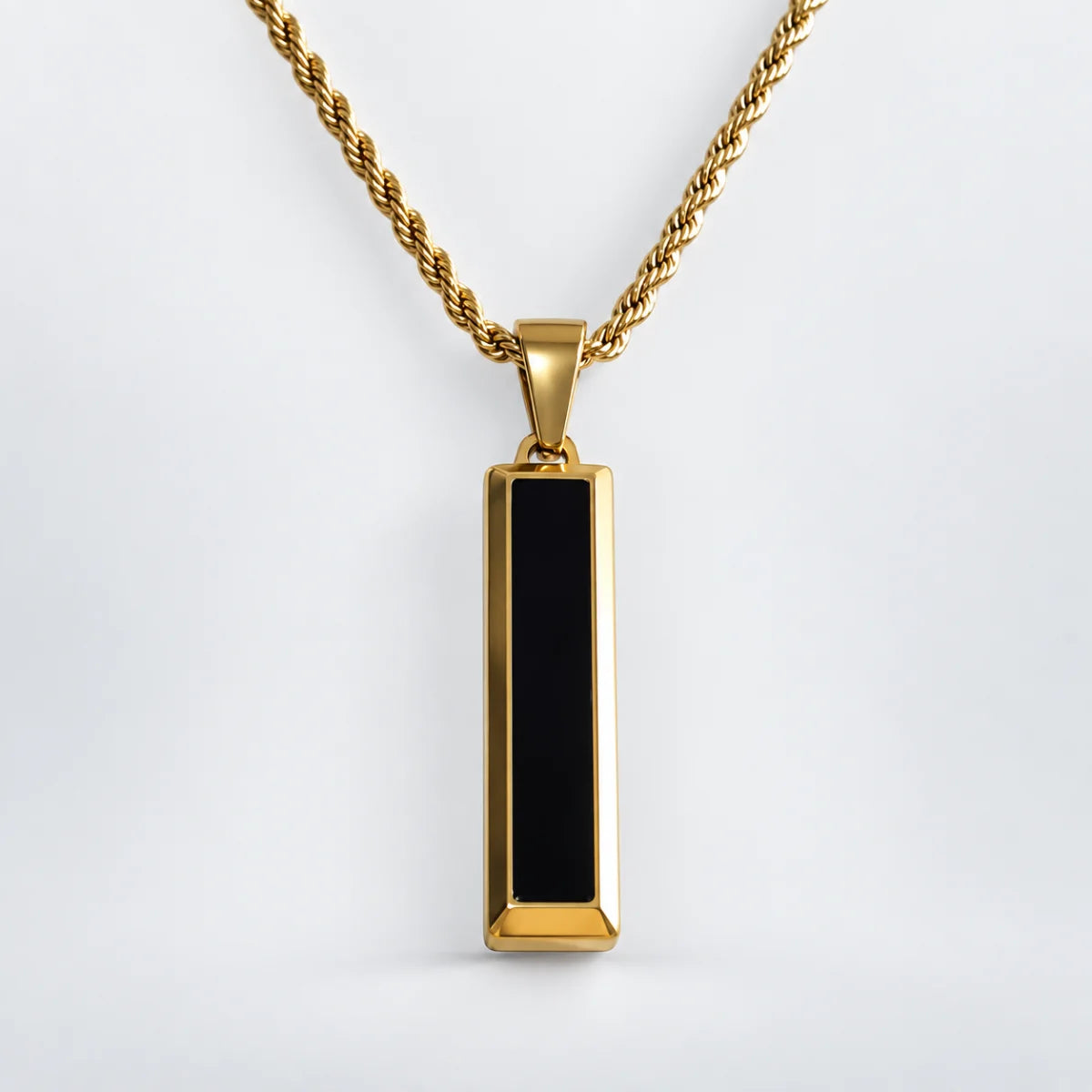black and gold bar necklace with rope chain white background
