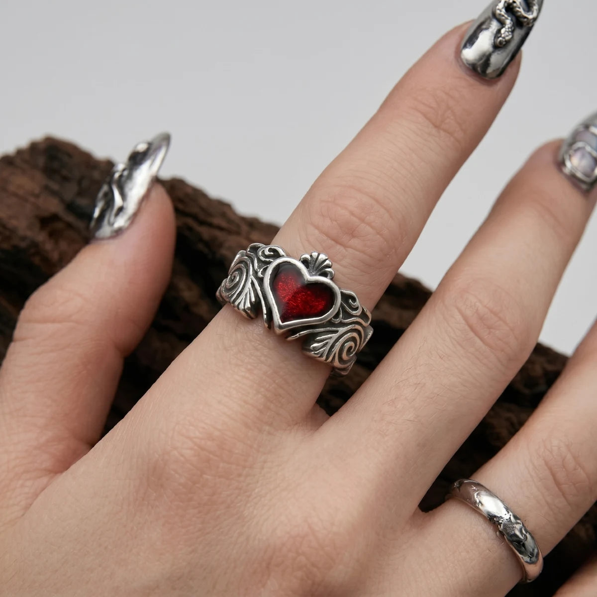Close Up Hand Wearing Gothic Heart Ring Baroque Scrollwork Witchy Jewelry