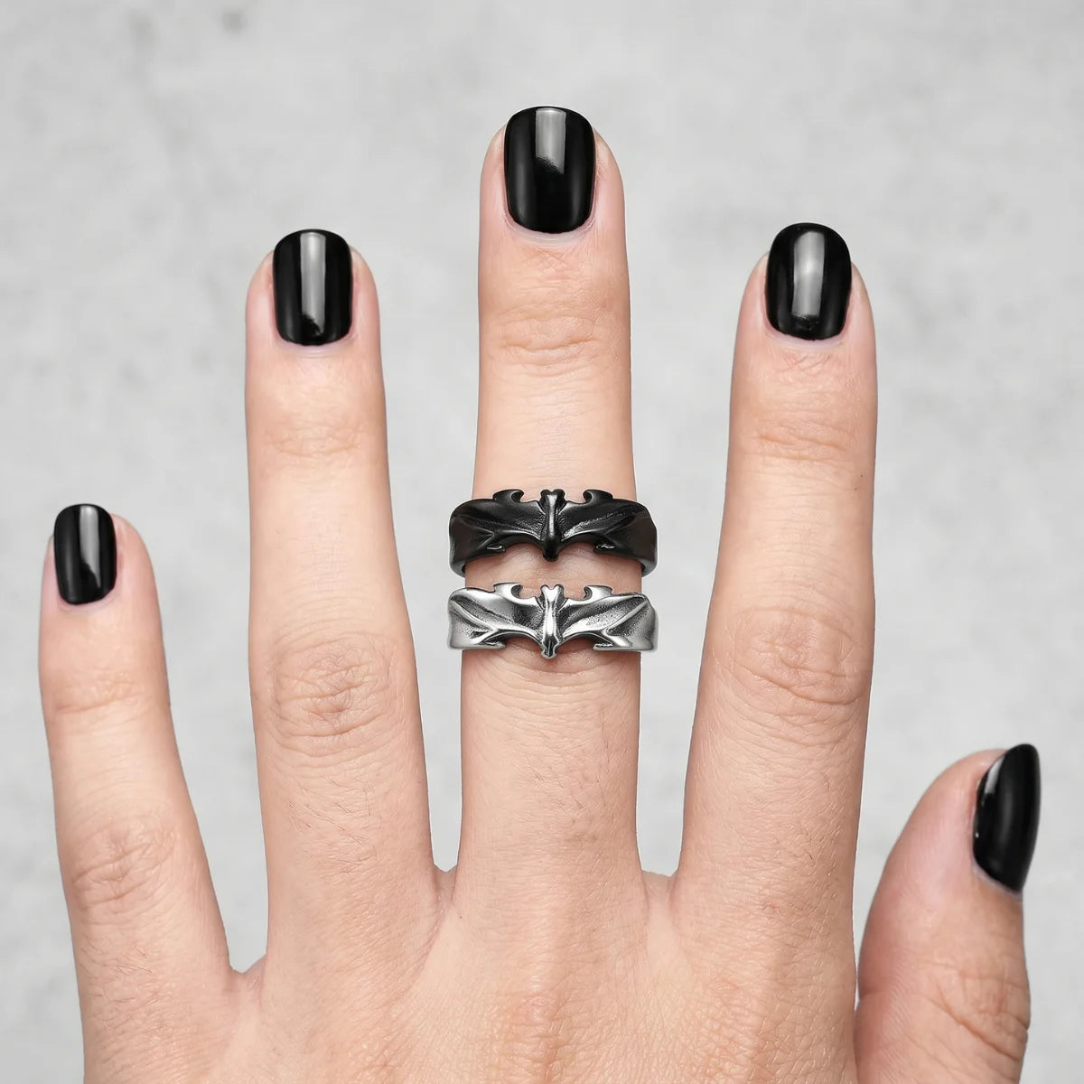 Close Up Hand Wearing Stacked Minimalist Bat Rings Alternative Vampire Jewelry
