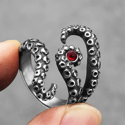 Close up holding silver Octopus Tentacle Ring with red crystal
