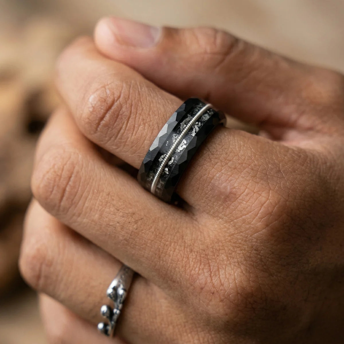 Close up of man wearing 8mm Guitar String Tungsten Ring wedding band