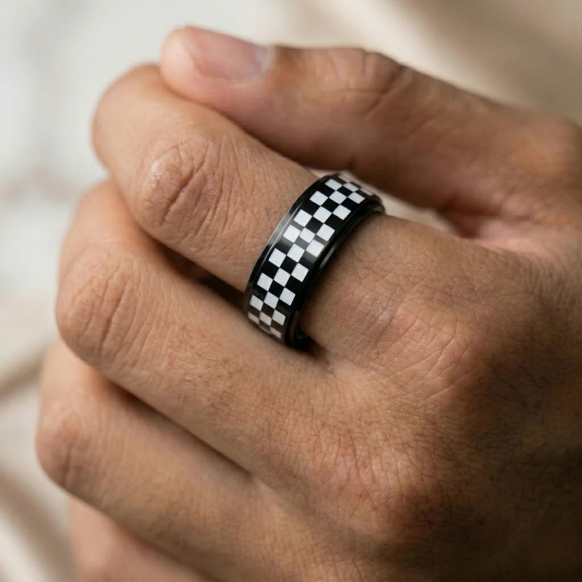Close up of man wearing black Checkered Spinner Band