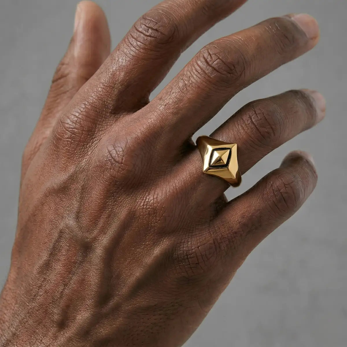Close up of man wearing gold Geometric Rhombus Ring