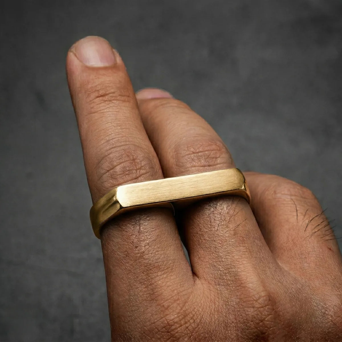 Close up of men‘s gold Two Finger Ring on hand