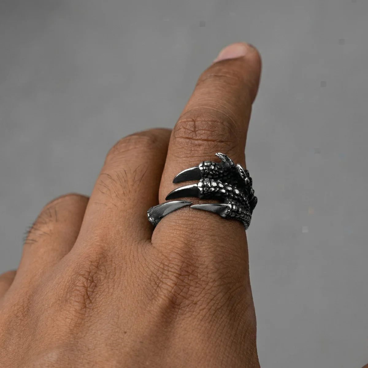 Close up of men’s silver Dragon Claw Ring on hand
