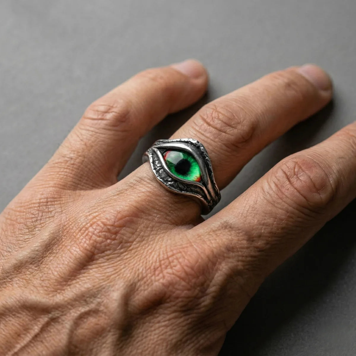 Close up of men‘s silver Green Eye Ring on hand