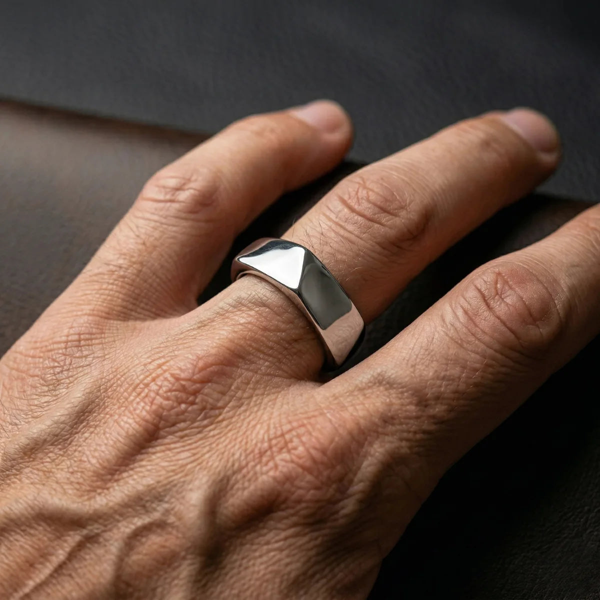 Close up of men’s silver Pentagon Ring on hand