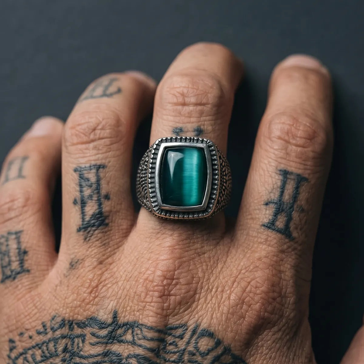Close Up Tattooed Hand Wearing Rectangular Cat Eye Signet Ring Dark Aesthetic Mens Jewelry