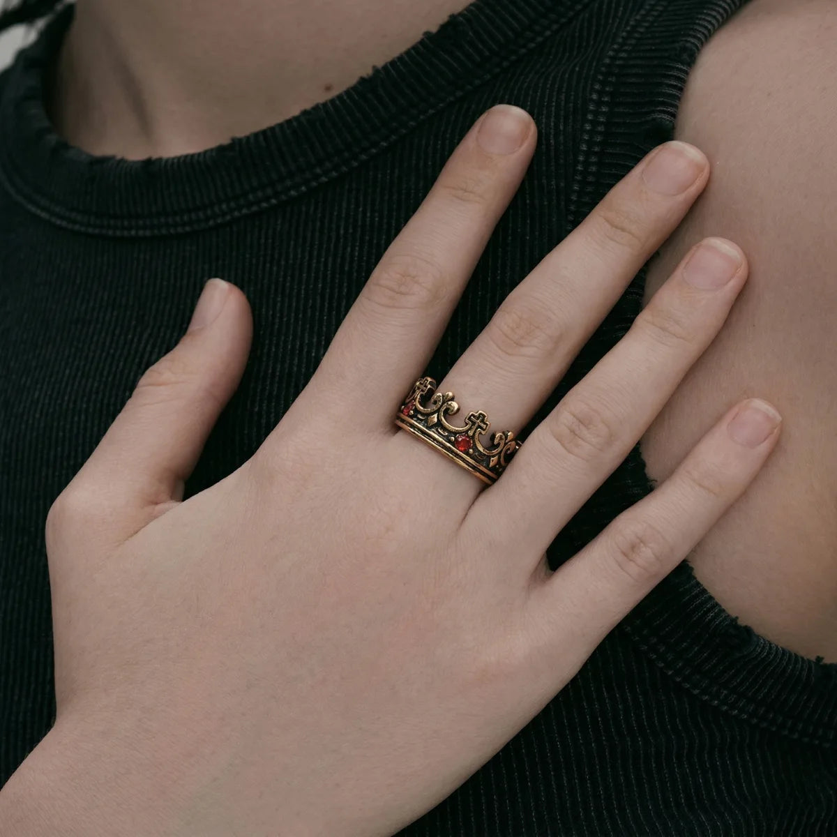 Close up of woman wearing gold Red Stone Crown Ring
