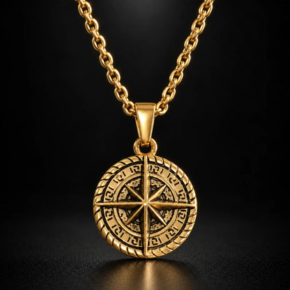 compass coin necklace gold black background hero