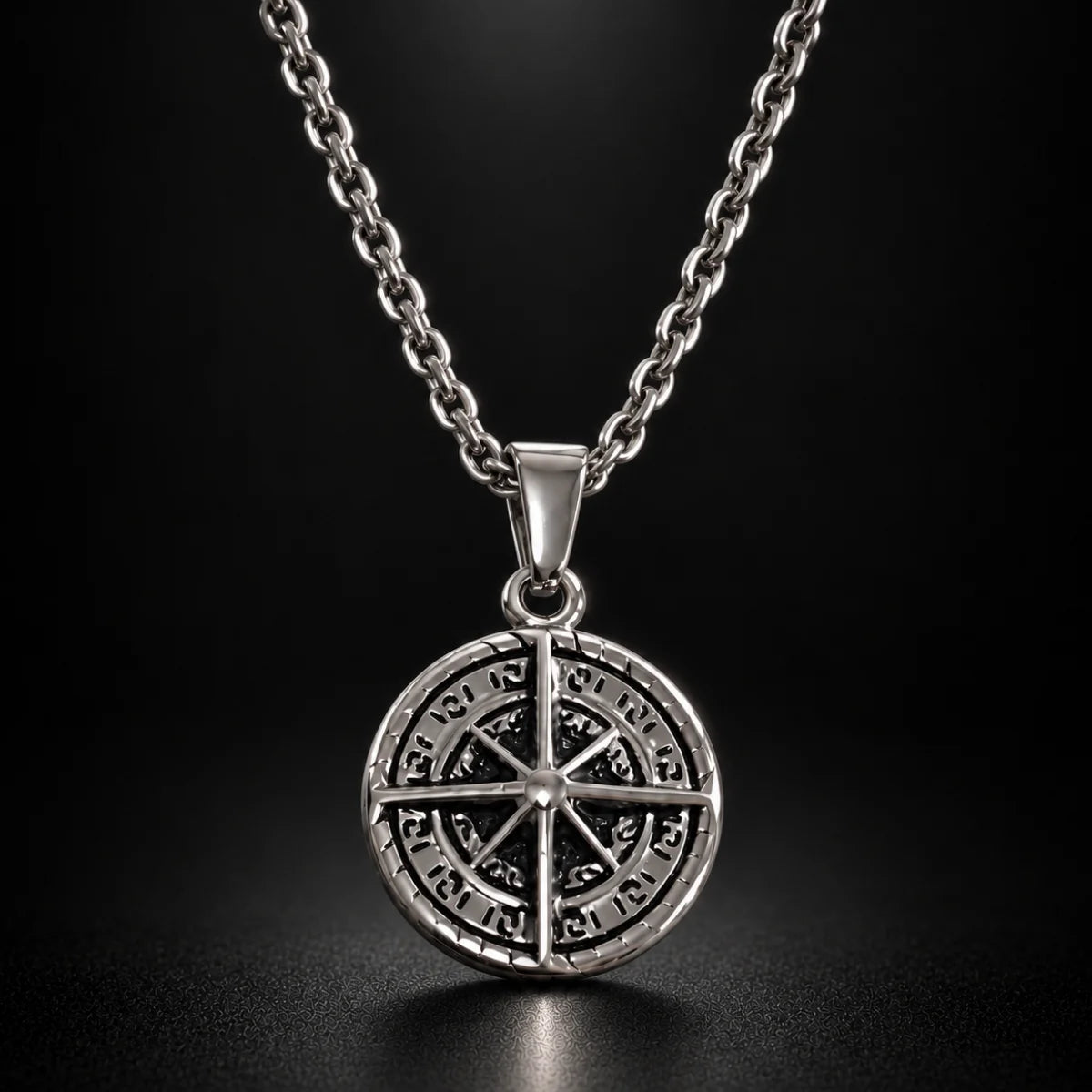 compass coin necklace silver black background hero