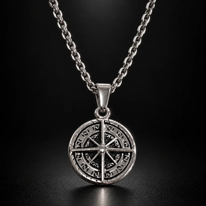 compass coin necklace silver black background hero