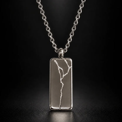 cracked bar necklace silver black background hero
