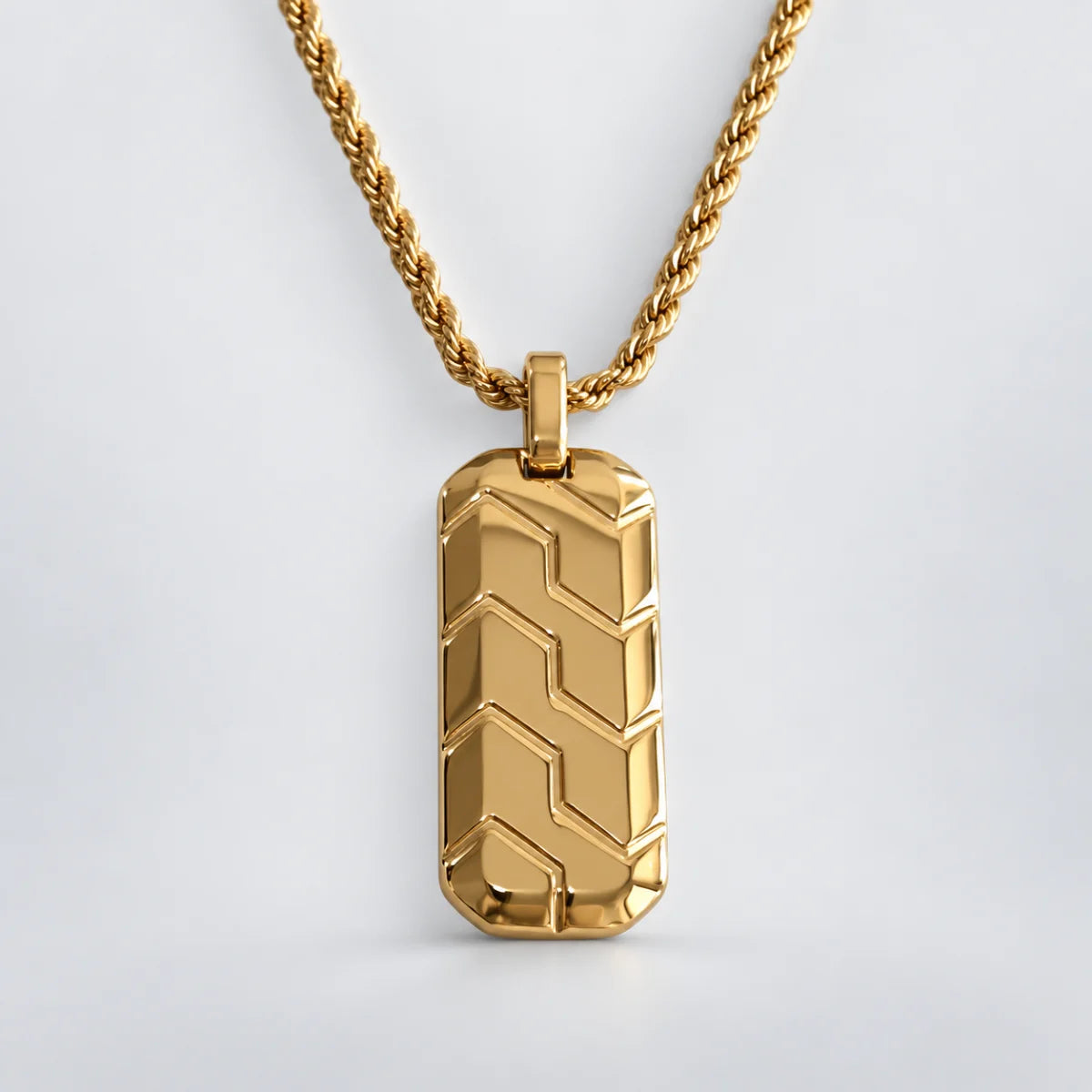 gold chevron dog tag necklace with rope chain white background