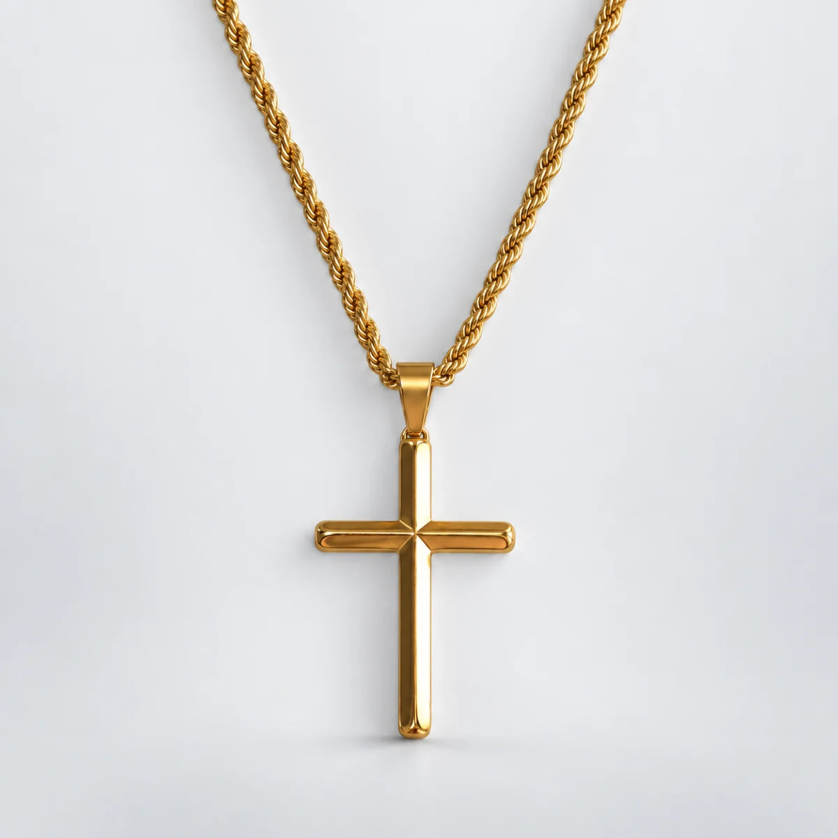 gold minimalist cross necklace with rope chain white background