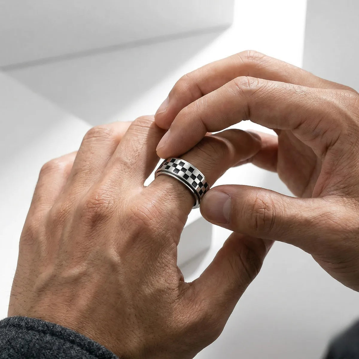 Man spinning silver Checkered Spinner Band