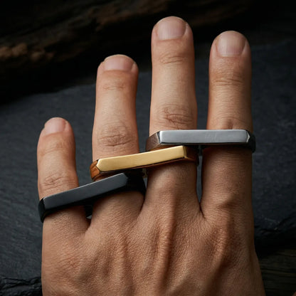 Man wearing black gold and silver Two Finger Rings