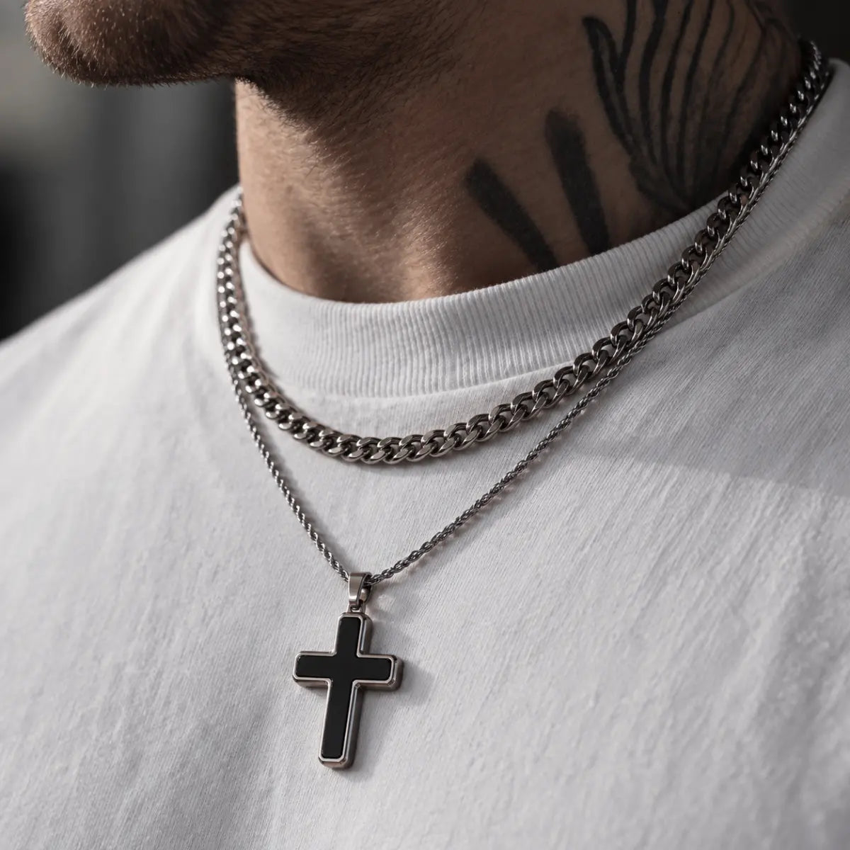 minimalist black cross necklace layered set lifestyle tattooed model