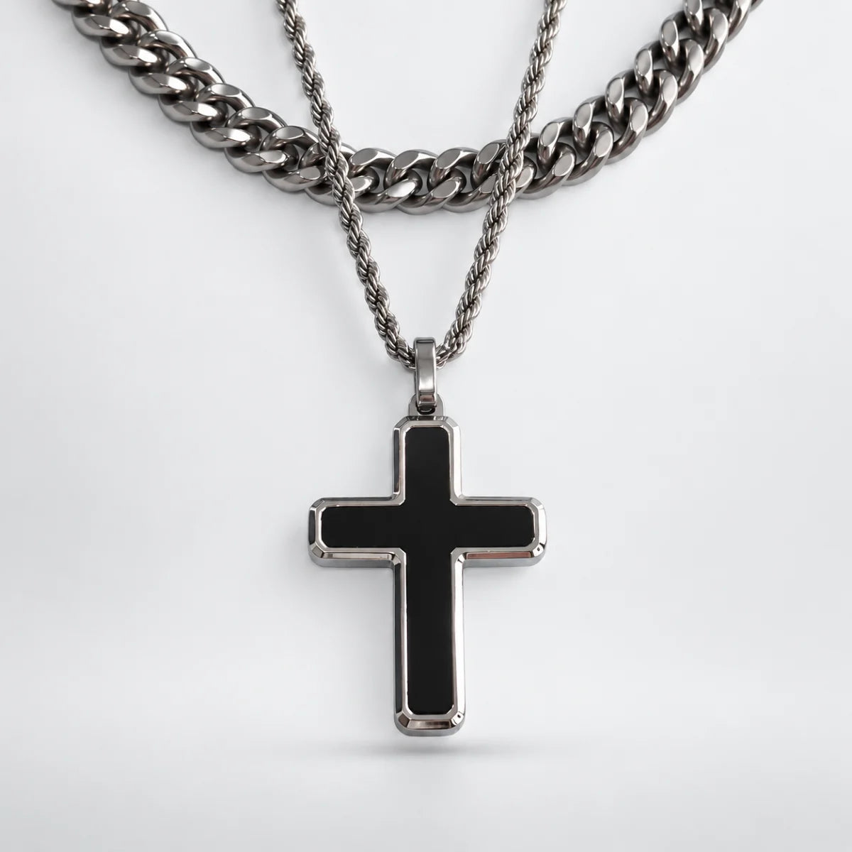 minimalist black cross necklace layered set white background