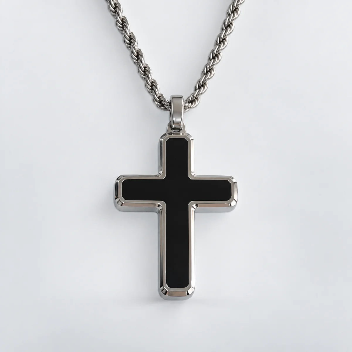 minimalist black cross necklace with rope chain white background