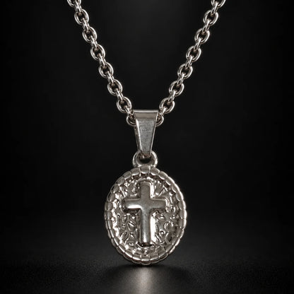 oval cross pendant necklace silver black background hero