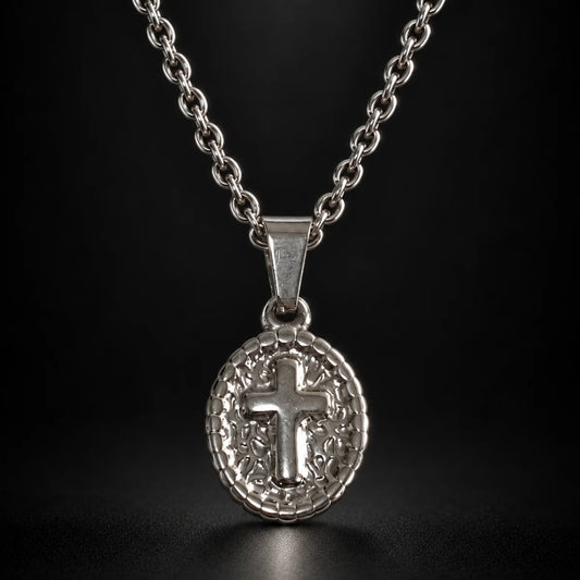 oval cross pendant necklace silver black background hero