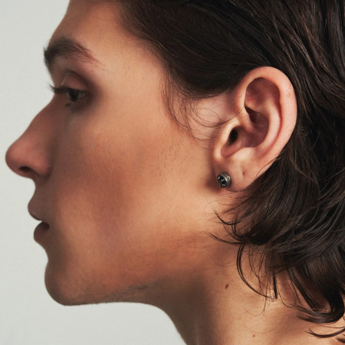Profile shot of man wearing Roman Numeral CZ Star Stud Earring