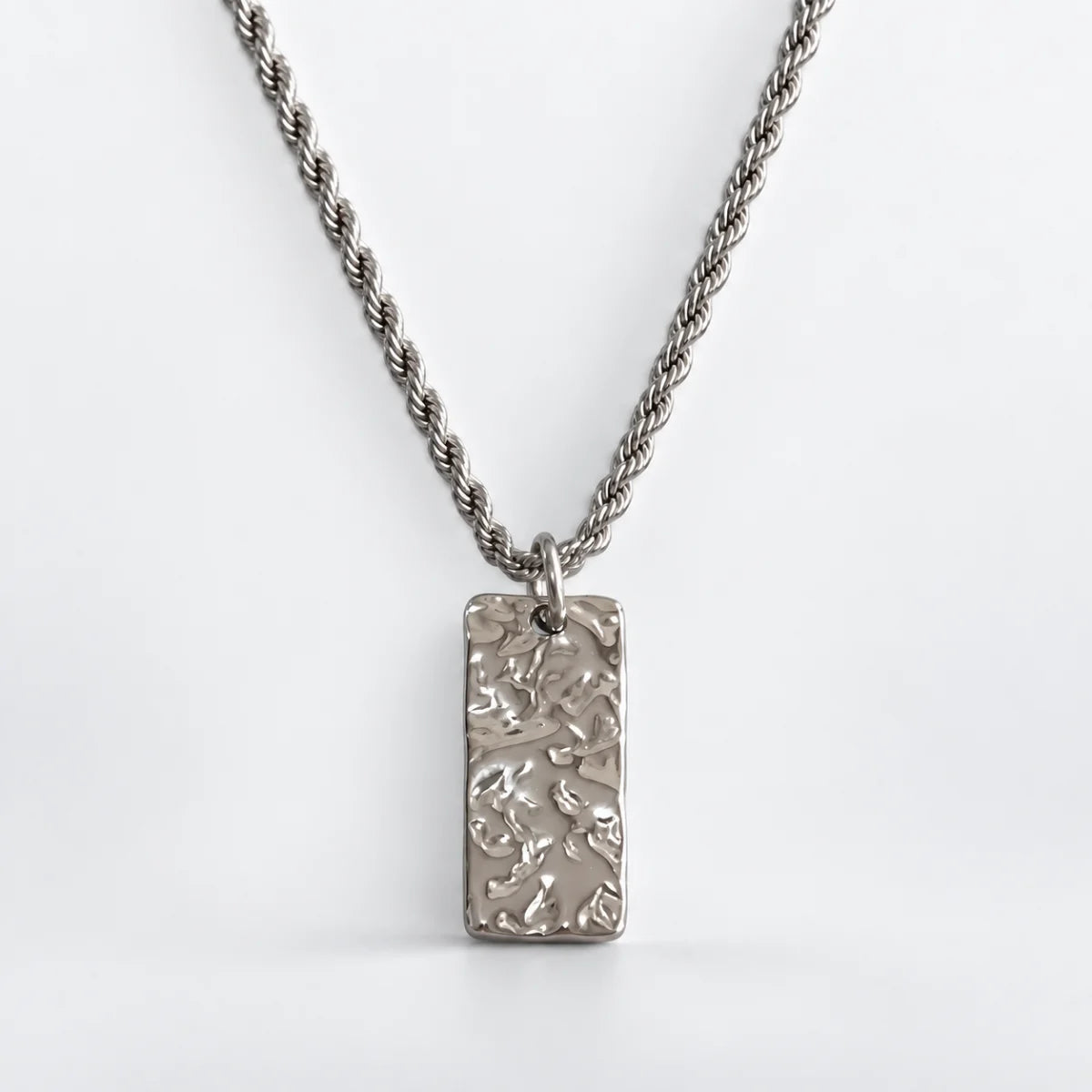 silver hammered rectangle necklace with rope chain white background