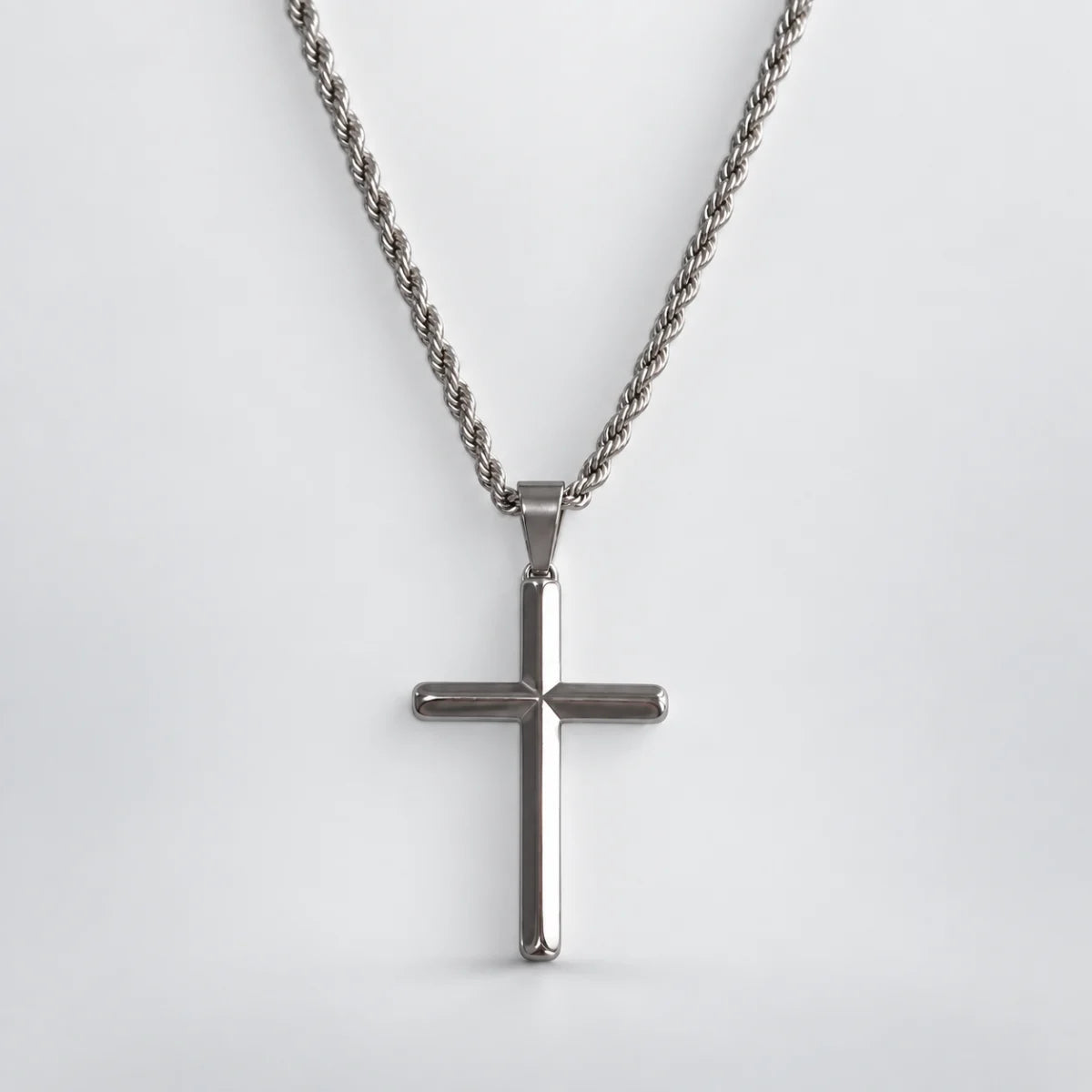 silver minimalist cross necklace with rope chain white background