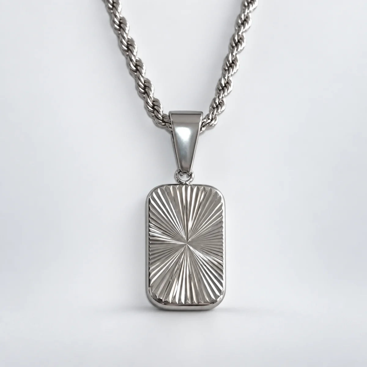 sunburst dog tag necklace with rope chain white background