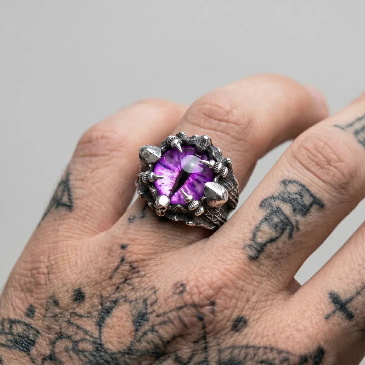 Tattooed Hand Wearing Talon Eye Ring Purple Eye Alternative Biker Accessories